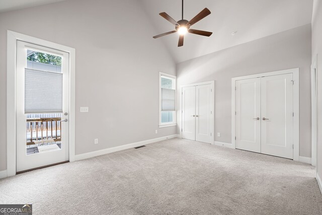 unfurnished bedroom with light carpet and multiple closets