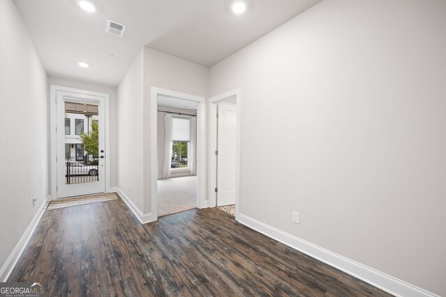 hallway with dark hardwood / wood-style flooring