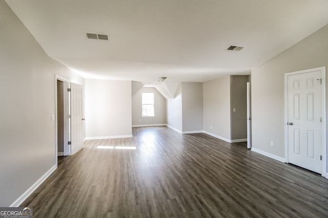 interior space with dark hardwood / wood-style floors and lofted ceiling