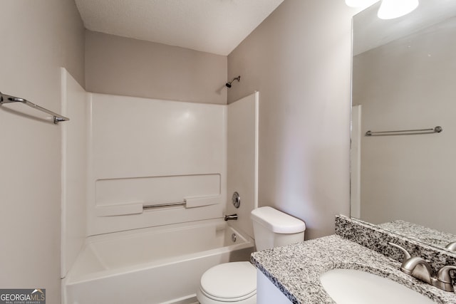 full bathroom featuring toilet, vanity, a textured ceiling, and tub / shower combination