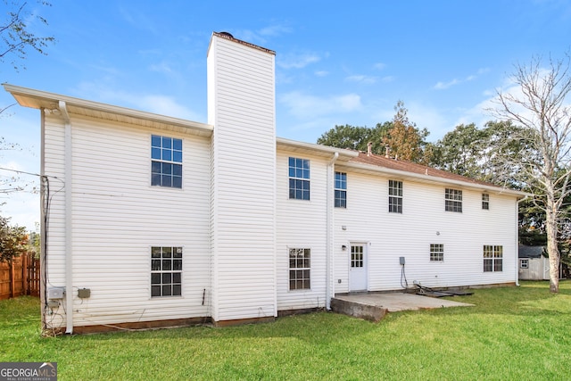 back of property featuring a lawn and a patio area