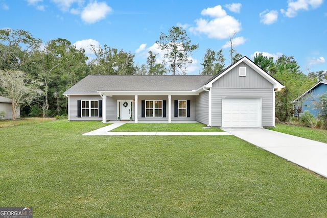 ranch-style home featuring a front yard, a garage, and covered porch