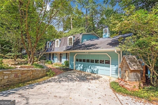 cape cod-style house featuring a garage