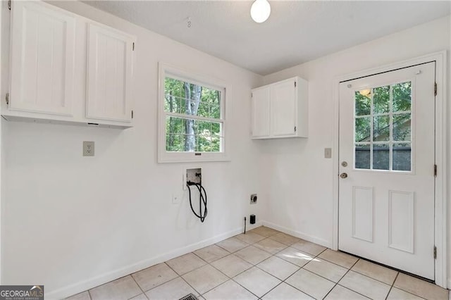 laundry room with washer hookup, cabinets, light tile patterned floors, and a wealth of natural light