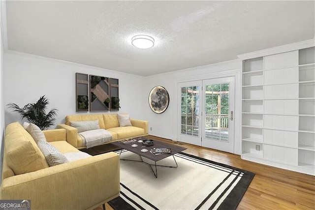 living room with hardwood / wood-style floors and a textured ceiling