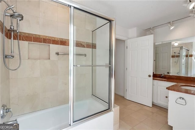 bathroom featuring tile patterned floors, vanity, and combined bath / shower with glass door