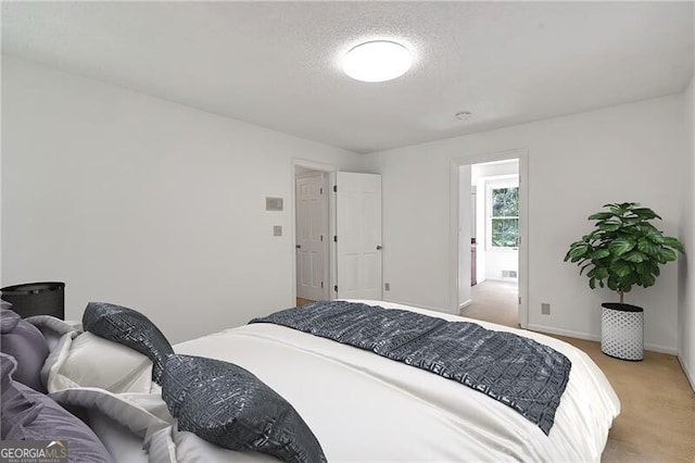 carpeted bedroom featuring a textured ceiling