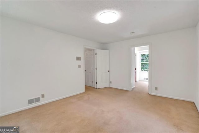 unfurnished room with light carpet