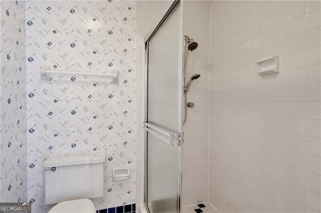 bathroom with toilet and an enclosed shower