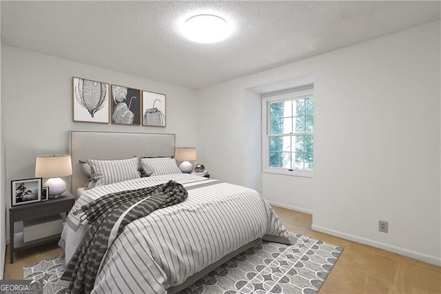 bedroom featuring carpet floors and a textured ceiling