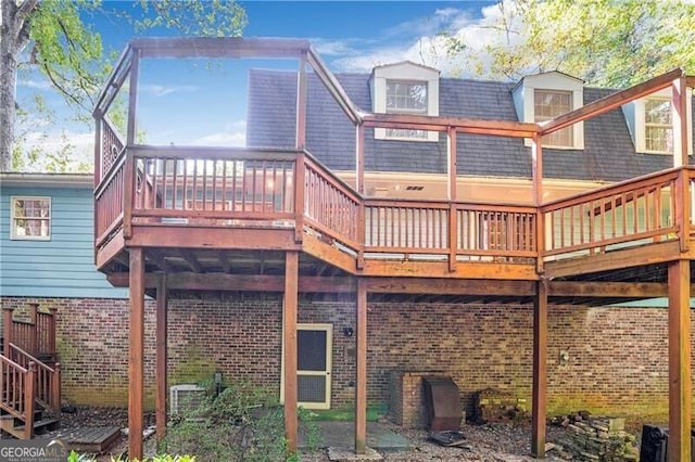 back of house featuring a wooden deck and central AC