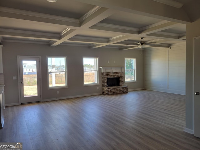 unfurnished living room featuring beamed ceiling, ceiling fan, wood-type flooring, and a fireplace