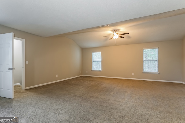 spare room with carpet, ceiling fan, and vaulted ceiling