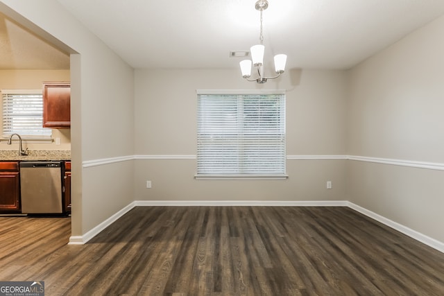 unfurnished dining area featuring dark hardwood / wood-style flooring, a notable chandelier, and sink