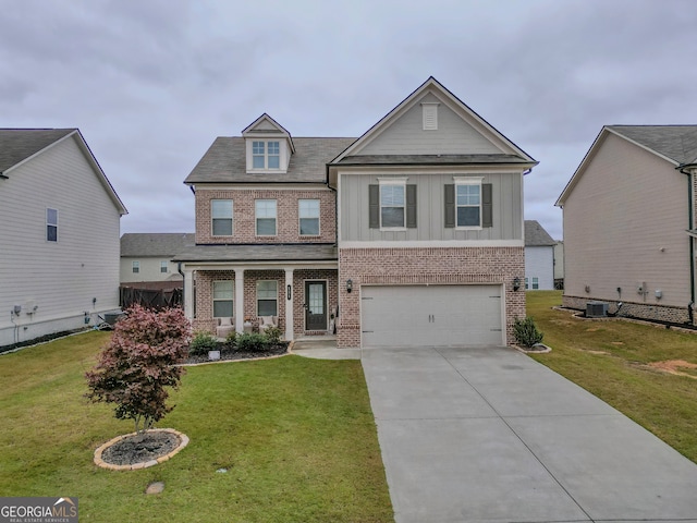 view of front of home featuring a garage, central air condition unit, and a front lawn