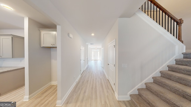 unfurnished bedroom with light colored carpet and a closet