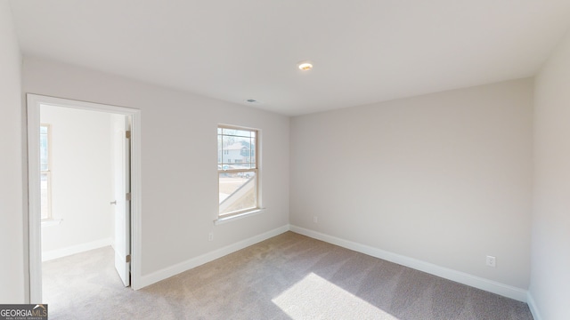 hall featuring dark colored carpet