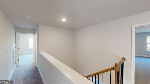 corridor with dark colored carpet