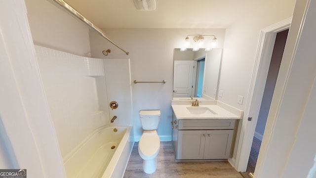 full bathroom with hardwood / wood-style floors, vanity,  shower combination, and toilet