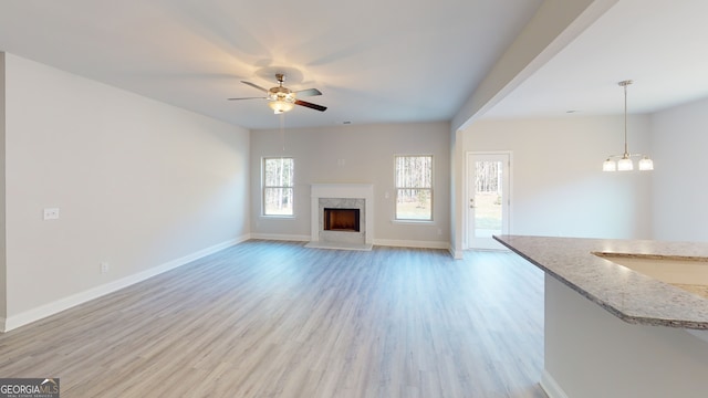 unfurnished living room with ceiling fan and light hardwood / wood-style floors