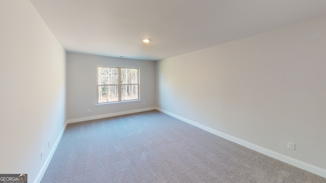 unfurnished bedroom with light carpet and a closet