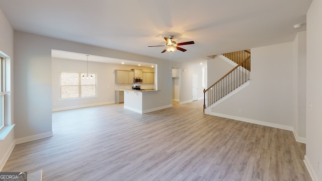 unfurnished room with light hardwood / wood-style floors, an inviting chandelier, and ornamental molding