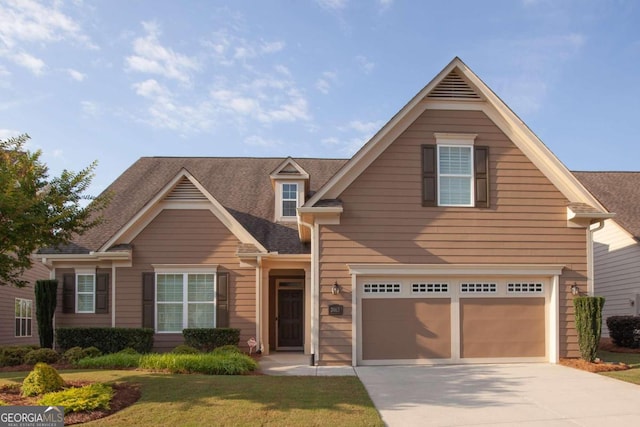 view of front of house featuring a front yard and a garage