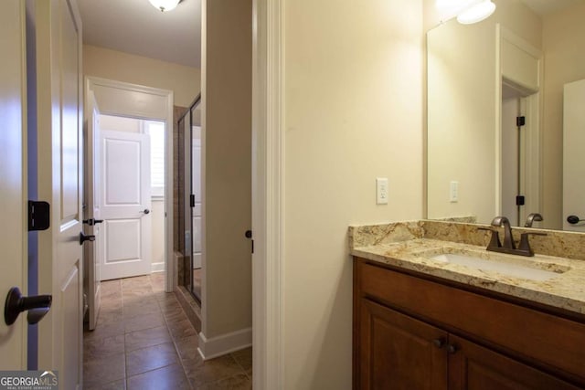 bathroom featuring vanity, tile patterned floors, and walk in shower