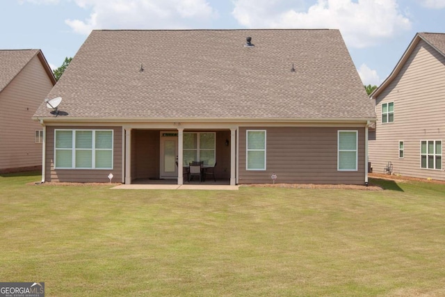 rear view of property featuring a yard and a patio