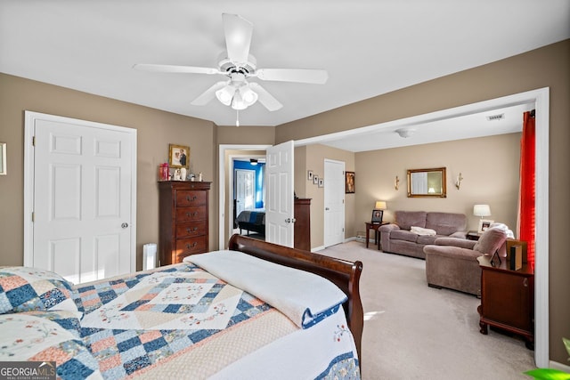 bedroom with ceiling fan and light carpet