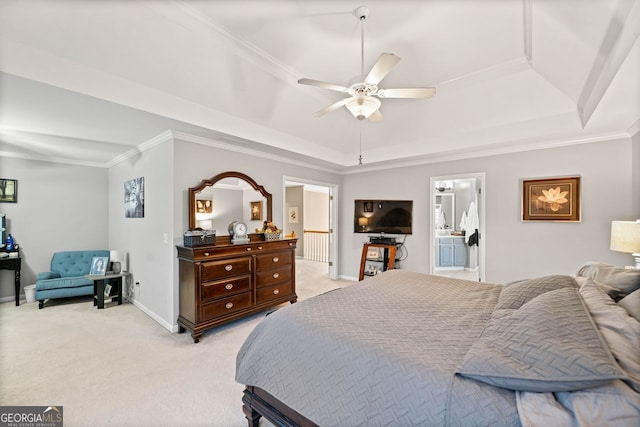 bedroom featuring ensuite bath, ornamental molding, light colored carpet, a tray ceiling, and ceiling fan