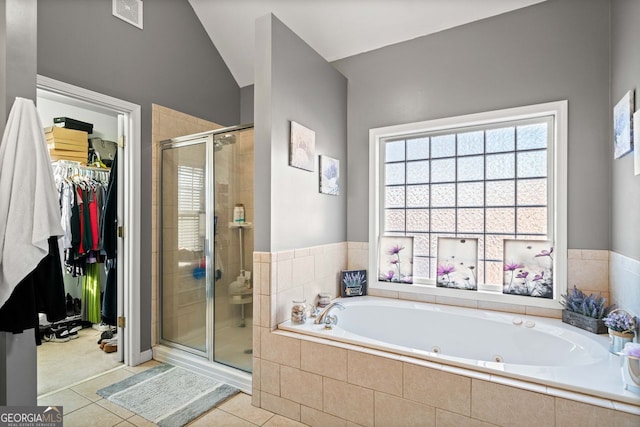 bathroom with tile patterned flooring, independent shower and bath, and vaulted ceiling