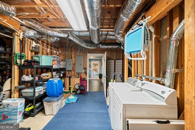 basement featuring separate washer and dryer and electric panel