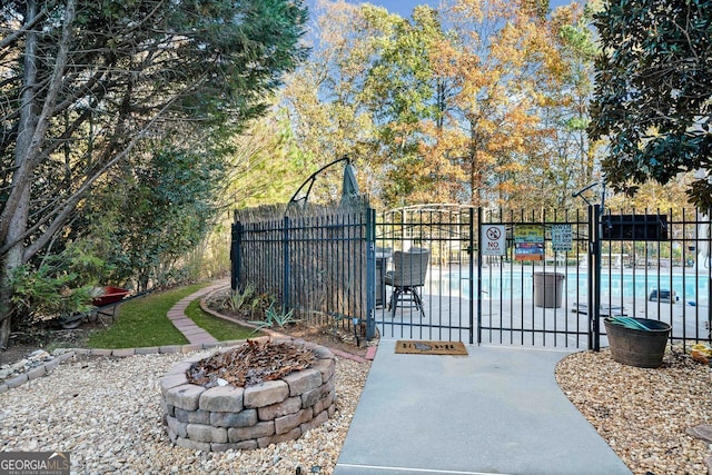 view of gate with a community pool