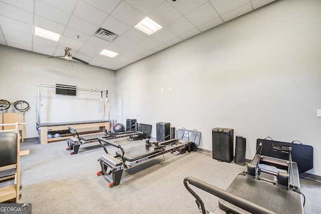 workout area featuring a drop ceiling and ceiling fan