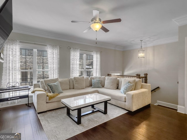 living room with ornamental molding, dark wood finished floors, a ceiling fan, and baseboards