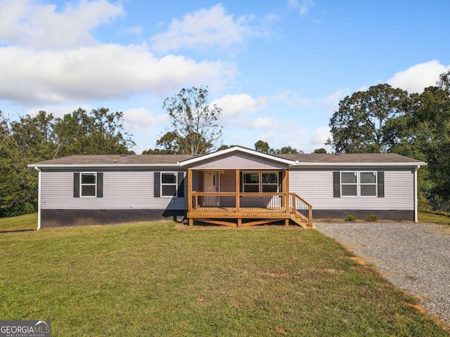 manufactured / mobile home with a front lawn and a deck