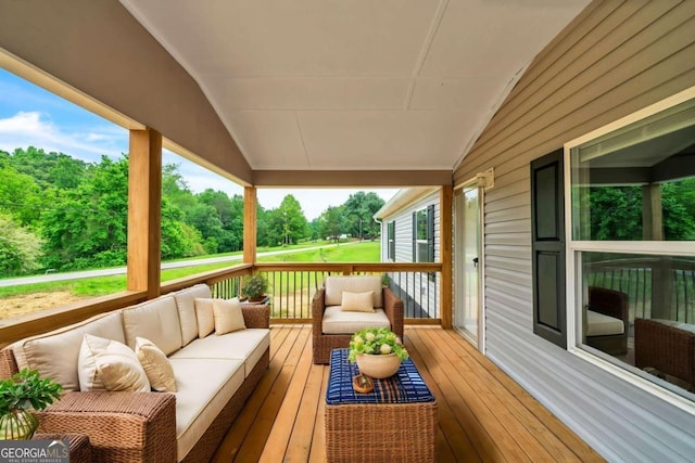 wooden deck with an outdoor living space