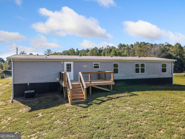 back of house featuring a lawn and a wooden deck