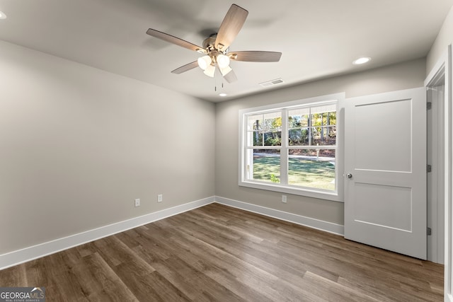 spare room with hardwood / wood-style flooring and ceiling fan