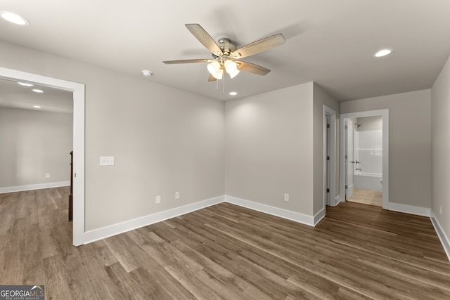 unfurnished bedroom featuring ceiling fan, dark hardwood / wood-style flooring, a spacious closet, and a closet