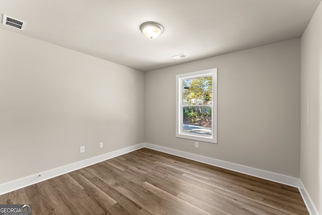 spare room with wood-type flooring