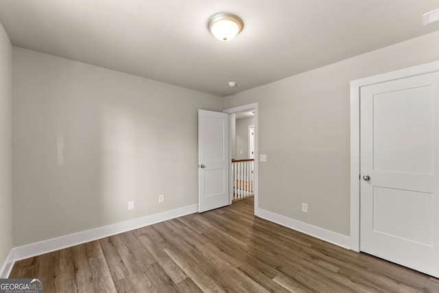 unfurnished room with wood-type flooring