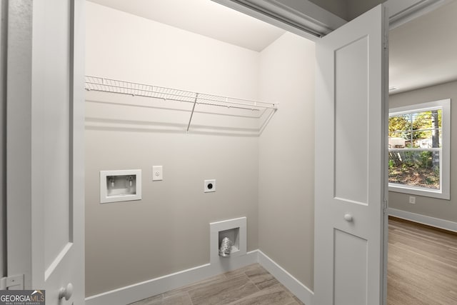 laundry room with washer hookup, electric dryer hookup, and light hardwood / wood-style flooring