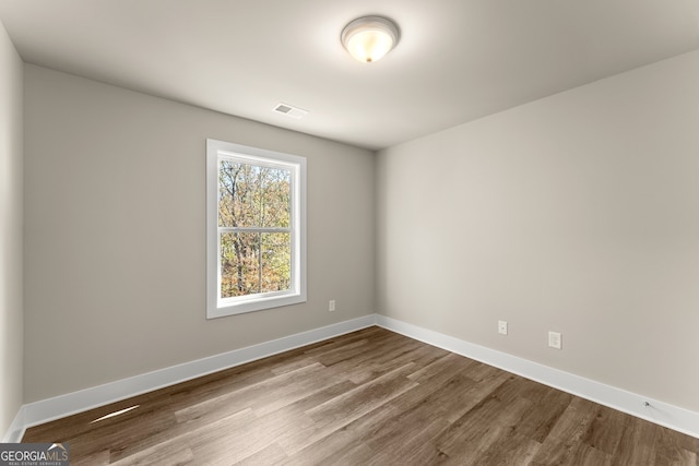 unfurnished room with hardwood / wood-style floors