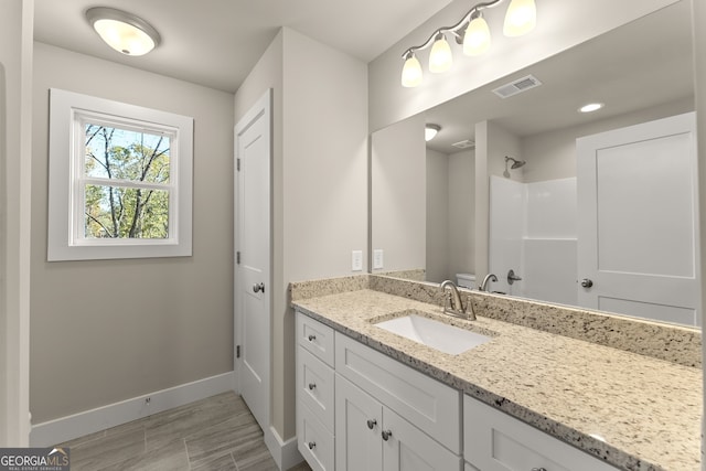 bathroom with a shower and vanity