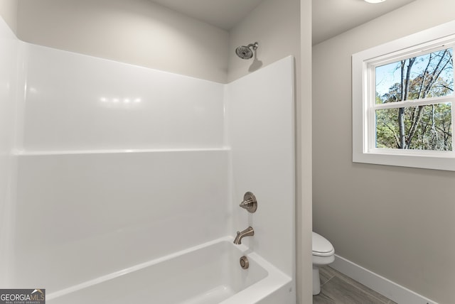 bathroom with shower / bath combination and toilet