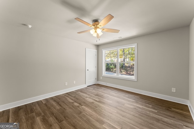 spare room with hardwood / wood-style floors and ceiling fan