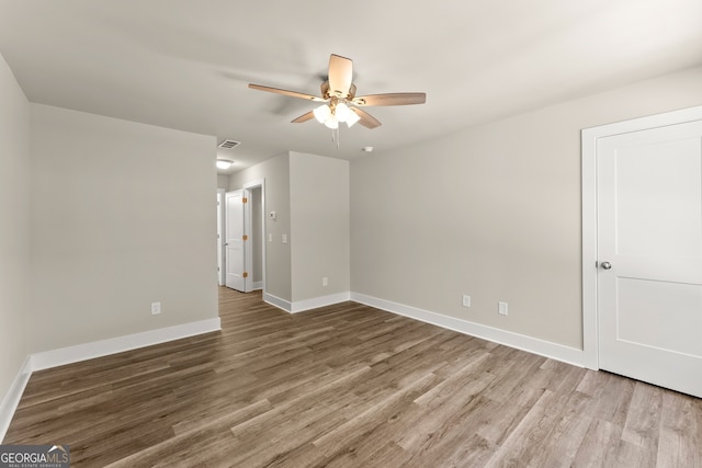 empty room featuring ceiling fan and hardwood / wood-style floors