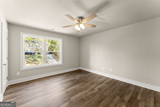 unfurnished room with ceiling fan and dark hardwood / wood-style flooring